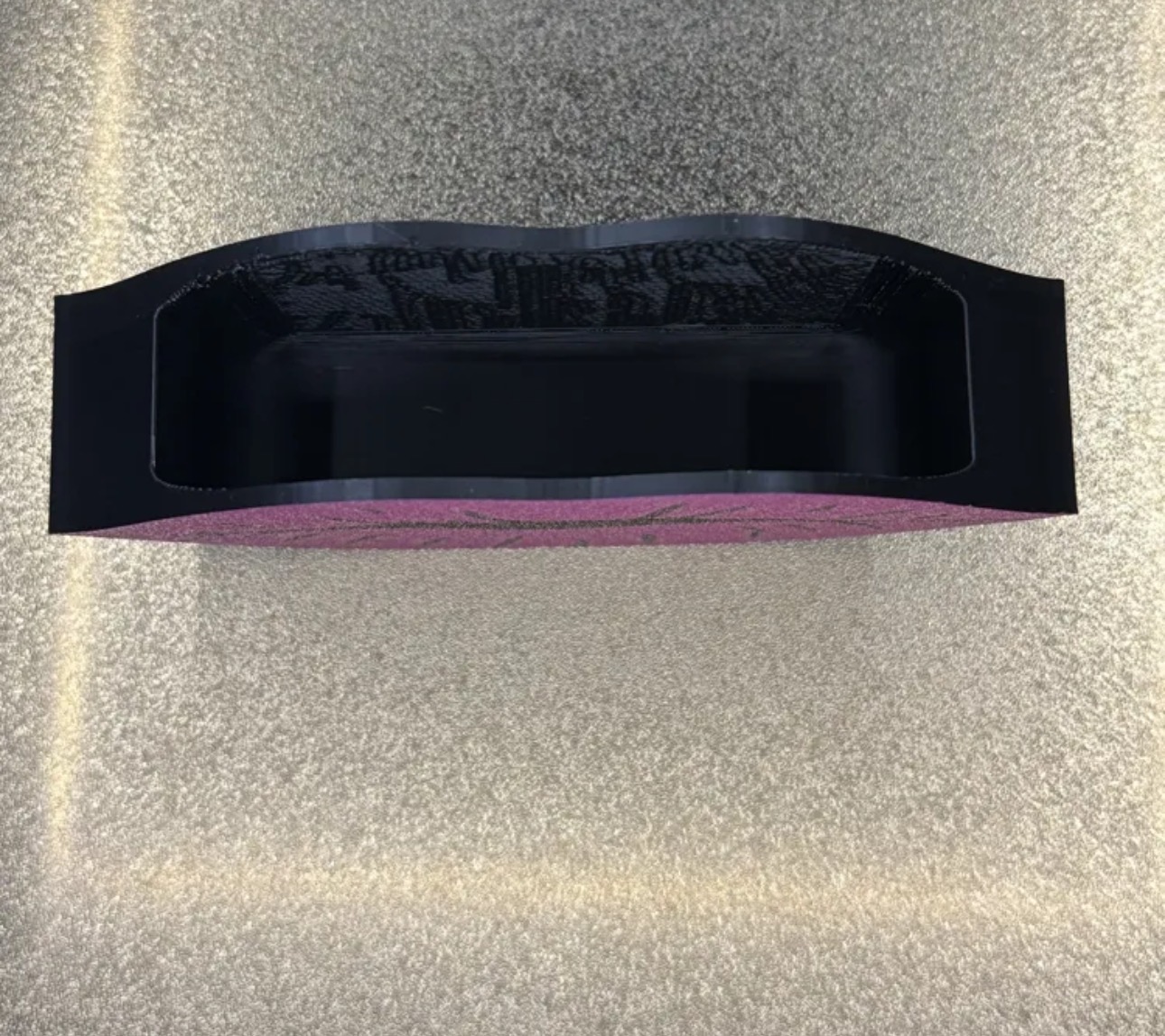 Top view of the lip holder showing its open storage compartment